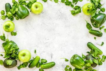 Vegetables for greeny smoothy with cucumber, pepper, apple, celeriac on stone background top view mock up