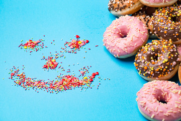 smiley and donuts on a beautiful blue colored background.