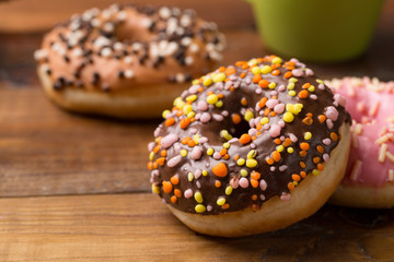 bright donuts on wooden background.