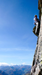 Fototapeta premium mountain guide rock climber on a steep granite route in the Alps of Switzerland on a beautiful day