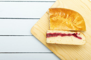 Fresh tart with cherries jam on cutting board. Copy space. Top view