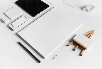 Blank stationery set on white paper background. Selective focus.