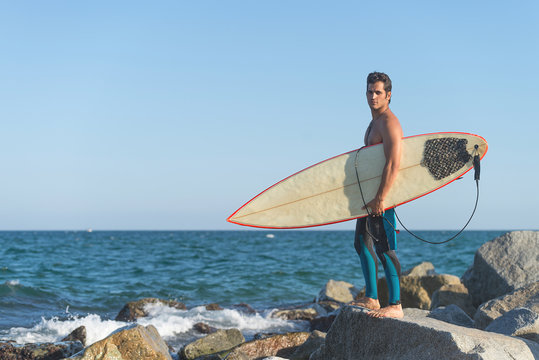 Man with surfboard on coast
