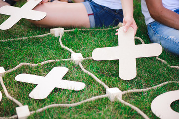 Boy and girl playing tic-tac-toe in the park