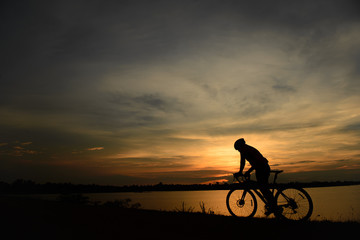 Silhouette of cyclists at sunset.,thailand people