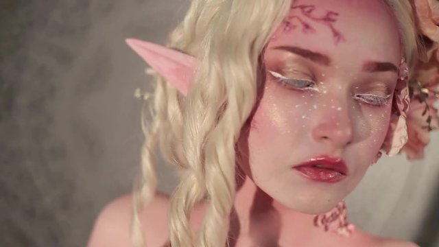 Fairy or elf in smoke, fantasy fairy tale. Mysterious magic elf portrait. Creative make-up and bodyart 