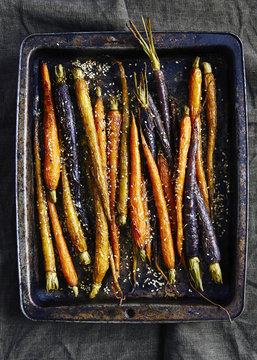 Roasted heirloom carrots on baknig tray, with zaatar after baking