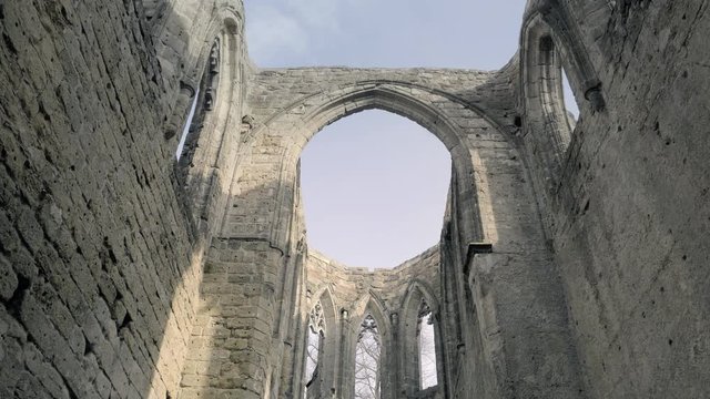 Gothic cathedral without roof. Ruins of medieval castle. Royal City. Scary giant building, huge defensive fortification tower and bulwark. Spring sunny day, without people. Oybin in Germany.