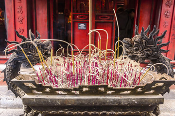 Incense burning in a bronze urn at Văn Miếu Quốc Tử Giám (Temple of Literature) in Hanoi,...