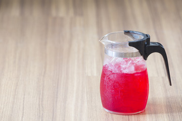 Sweet drink on wooden. Salacca juice on wood background.