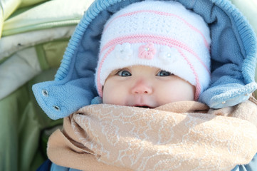 Happy smiling baby portrait in warm clothes in coat. Winter weather overall for little child