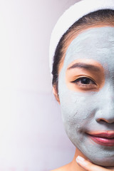 A woman is marking a face.