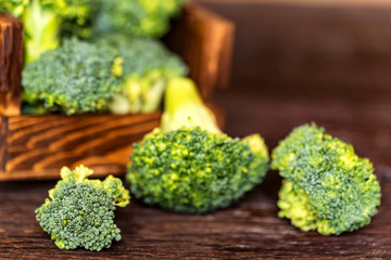 Fresh broccoli in wooden box on wooden surface