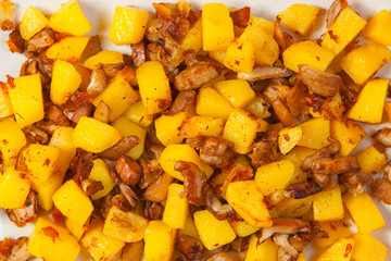 fried potatoes with mushrooms on plate