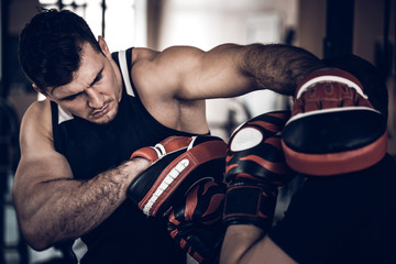 Boxing workout with trainer and punch mitts
