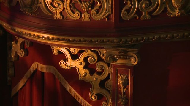 Ornamental gold wall patterns red velvet curtains carnival circus style