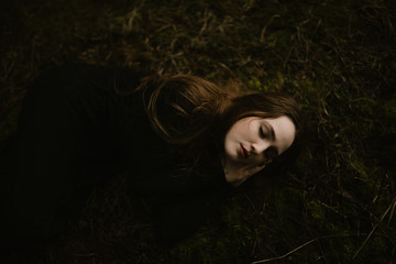 Young Woman Sleeping Outside on a Mossy Forest Floor © Eastlyn Bright