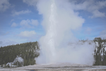 Hot Spring at Yellowstone National Park in Winter with snow and clear sky