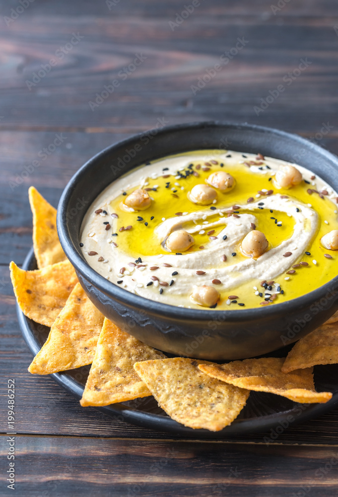 Poster bowl of hummus with tortilla chips