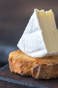 Toast with Camembert cheese on the wooden board