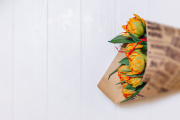Bouquet of tulips in paper on white background