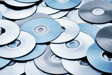 Random abstract arrangement of blue DVD and CD disks create data concept background