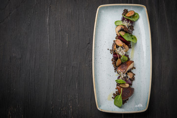 Portobello mushrrom with black lentils, roasted beetroot and spanish capers and copy space