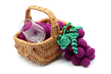 Fototapeta na wymiar crochet wine grapes in basket with vine glass on white isolated background.