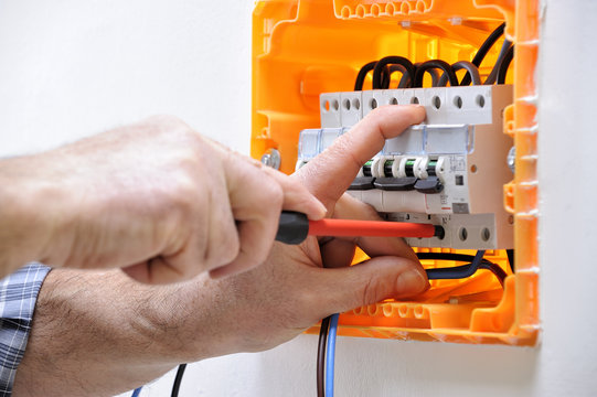 Electrician technician at work on a residential electric panel