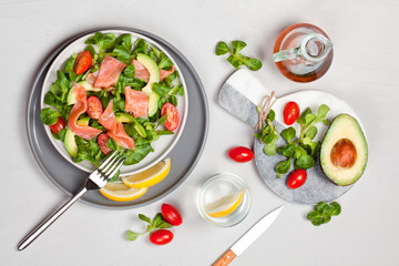 Fresh salad made of salmon, tomatoes and avocado