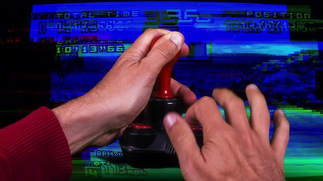 a hand using a retro computer arcade game joystick