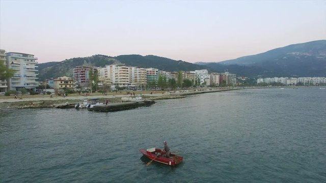 Man paddling boat on the water in Albania