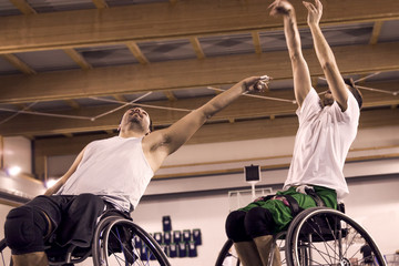 disabled sport men in action while playing basketball