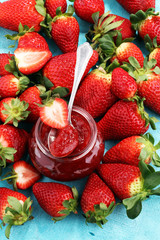strawberry jam with fresh strawberries. marmalade on spoon and jar