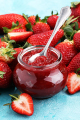strawberry jam with fresh strawberries. marmalade on spoon and jar