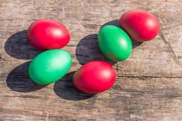 Painted Easter eggs on rustic wooden background