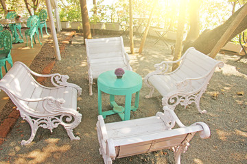 Interior of tiffany. Beautiful summer cafe in tiffany colors. Forged iron wooden white chairs with...