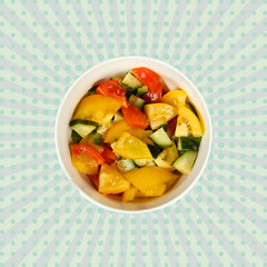 Vegetable salad of cucumbers and tomatoes in a white cup on a colored background