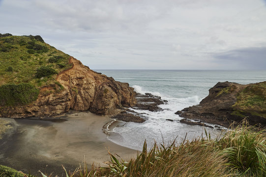 View to the Tasman Sea over volcanic black sand beach at Piha, New Zealand's premier surfing resort, North Island, New Zealand
