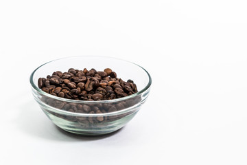 coffee beans in a transparent cup on a white background