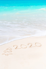 2020 year written on white sandy beach