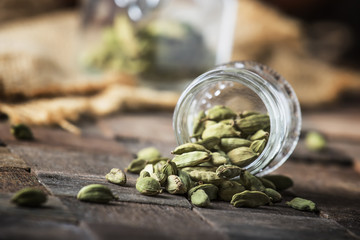 Dry whole cardamom, vintage wooden background, selective focus