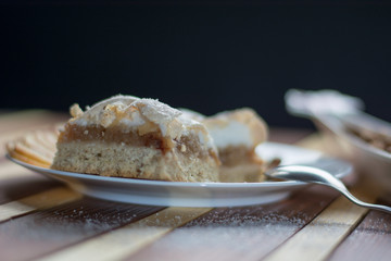 Square shape sliced omemade apple pie with kumquats and almonds