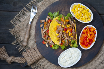 Mexican tacos - traditional dish with ingredients meat and vegetables
