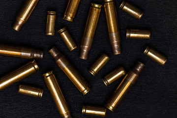 empty cartridges on a black