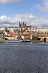 Obraz premium Early Spring Prague gothic Castle with the Lesser Town above River Vltava in the sunny Day, Czech Republic