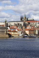 Obraz premium Early Spring Prague gothic Castle with the Lesser Town above River Vltava in the sunny Day, Czech Republic