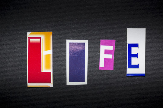 letters cut out from newspapers and magazines that form the word "life", on a black background