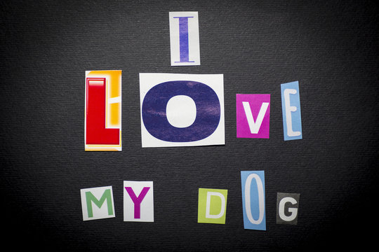 letters cut out from newspapers and magazines that form the phrase "I love my dog", on a black background