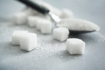 Fototapeta na wymiar Refined sugar on gray background